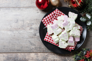 Christmas marshmallow and Christmas decoration on wooden table. Top view. Copy space