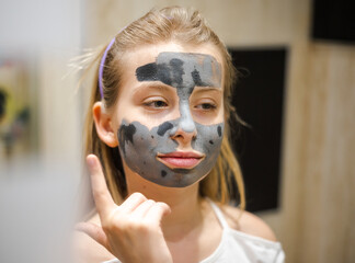 Preteen Girl with Clay Mask Beauty Treatment for Acne Close-Up