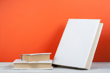 Open book, hardback colorful books on wooden table. Back to school. Copy space for text. Education business concept.