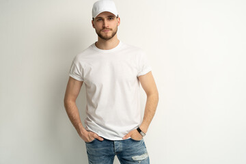 Handsome man wearing blank white cap and white t-shirt isolated on white background. - obrazy, fototapety, plakaty