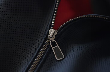 Closeup of steel zipper on leather jacket. Zipper replacement services concept © H_Ko