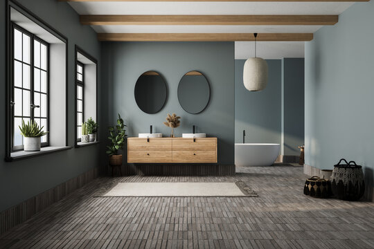 Elegant bathroom with blue tones walls, white basin with oval mirrors, bathtub, shower, plants, and tiled floor. Boho scandinavian bathroom.