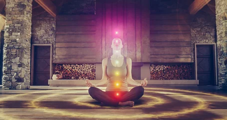 Schilderijen op glas Beautiful Relaxed Caucasian Woman In Lotus Position Meditating In Zenlike Openair Space. Edited Visualization Of Multi Colored Chakras Glowing On Her Body. Spirituality, Yoga, Self-care Concept. © Kitreel