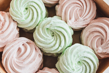 Pink and green homemade zephyr or marshmallow in the box. Soft focus