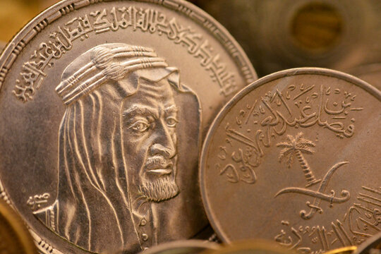 An old vintage retro Saudi Arabia coin at the Era of king Faisal, An Egyptian One 1 LE EGP silver pound coin with the slogan of King Faisal Bin AbdulAziz Al Saud, commemorative coin after his death