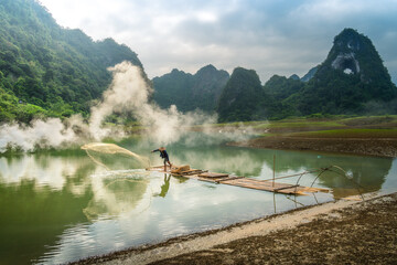 view of fishermen fishing on river in Thung mountain in Tra Linh, Cao Bang province, Vietnam with lake, cloudy, nature