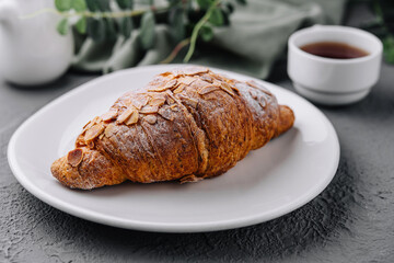 Almond Croissant on plate with Tea