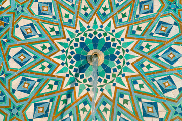 Colorful zellige tiles of a fountain in Morocco. Moroccan Mosaic pattern, traditional Islamic geometric design. Moroccan craft, handmade.