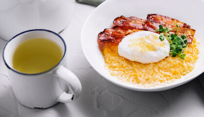 breakfast barley porridge with bacon and a poached egg