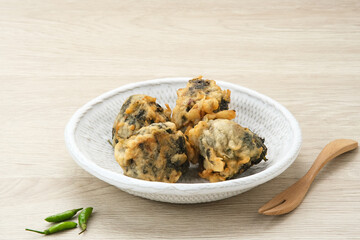 Rolade Tahu, cassava leaves with tofu crumbs fried in flour. Indonesian snack
