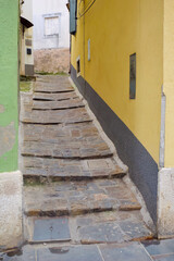 Steep cobblestone narrow passage between houses in an old European town