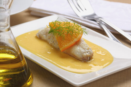 Monkfish fillet with orange and dill sauce.