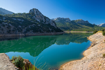 Fototapeta na wymiar A small lake, Torrent de Gorg Blau, located among the rocks in Mallorca, Spain.