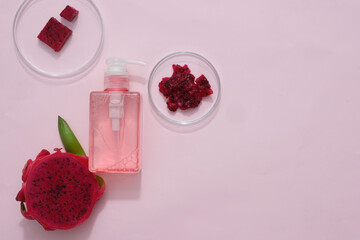 Viewed from above, chopped red dragon fruit is placed in two petri dishes, an unlabeled cosmetic...