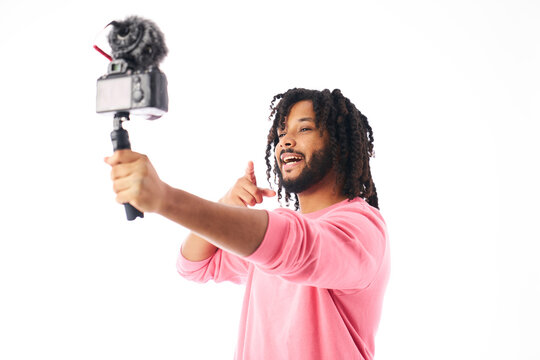 a young man with braided hair happily talking to camera on streamen