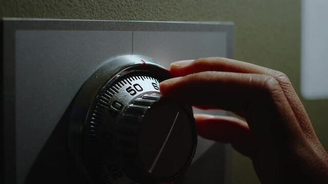 Turning a password on dial for open the safe box.