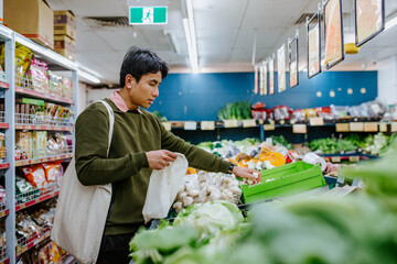 Man buying fresh produce at supermarket