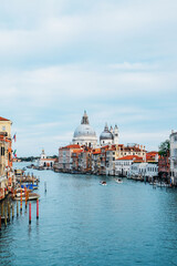 Fototapeta premium Famous view of Venice Grand Canal with Saint Mary of Health dome on sunny day from Ponte dell'Accademia bridge. Italian travel destination and landmark, tourist attraction.