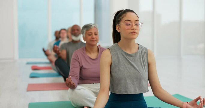 Woman, coach and zen meditation in yoga class for spiritual wellness, awareness or stress relief. Calm female person or yogi with group in mediating for healthy mind, body and health in fitness