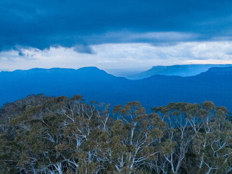 Scenic View Of Tree Covered Landscape In Blue Mountains With Approaching Storm