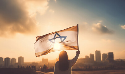 Woman raising flag of Israel. feminism,human rights,conflict Palestina concept. Jewish girl standing with the flag of Israel on the amazing valley and city and sky background. Memorial day-Yom,