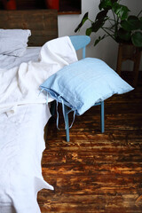 Fototapeta na wymiar Blue linen pillow in bedroom bedclothes