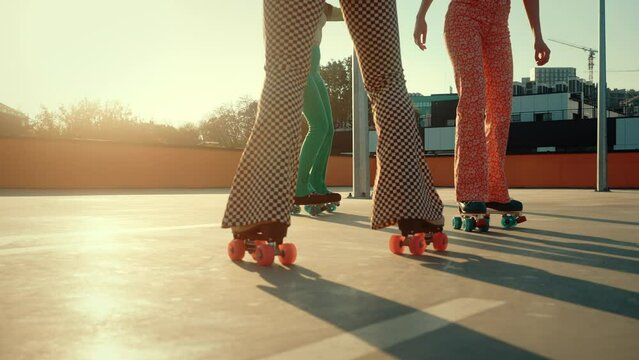 Pin-up women riding roller retro skates in urban place