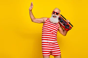 Foto op Canvas Photo of carefree old pensioner raised palm up dancing listen vintage cassette player at the beach club isolated on yellow color background © deagreez
