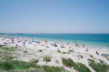View of people enjoying a summers day at the beach