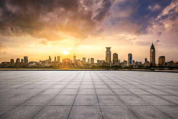 Brick floor and city buildings skyline in Shanghai at sunset