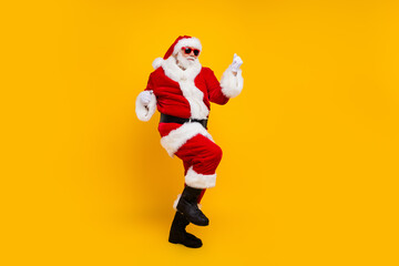 Full length photo of overjoyed aged santa raise fists triumph new year miracle isolated on yellow color background