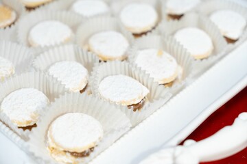 there is some cookies with powdered sugar on them and a red table cloth