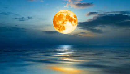 night sky with orange moon in the clouds over the calm blue sea elements of this image furnished by nasa