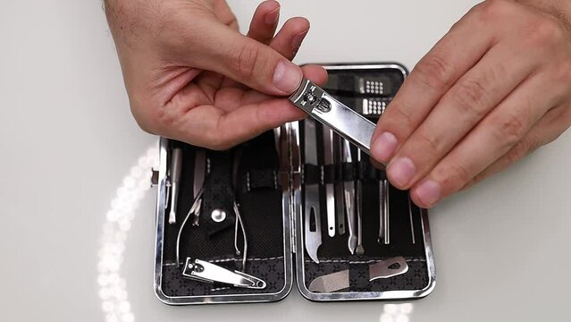 Bites his nails off with nail clippers Men's manicure at home.
