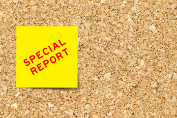 Yellow note paper with word report on cork board background with copy space