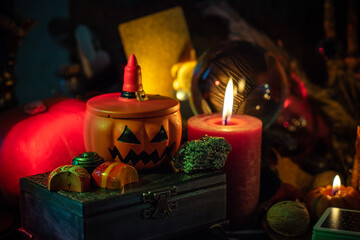 Halloween party, close up magical details including pumpkin and many candles, Home design 