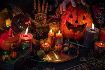 Halloween party, close up magical details including pumpkin and many candles, Home design 