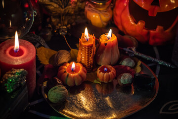 Halloween party, close up magical details including pumpkin and many candles, Home design 