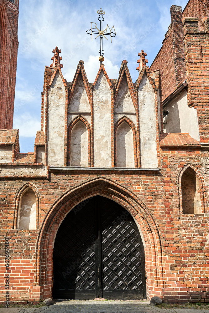 Wall mural entrance to the historic medieval church of the Assumption of the Blessed Virgin Mary in the city of Torun