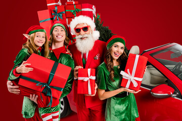 Funny four people costume theme x-mas party preparation concept hold presents isolated white color background