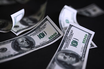 Dollar banknotes flying on black background, collage. Banner design - obrazy, fototapety, plakaty