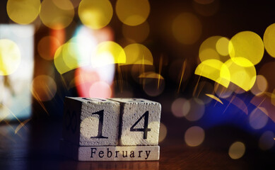 Wooden calendar 14th of February on bokeh background