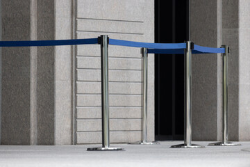stainless steel bollard with blue line barricade in front of the entrance office buliding. Stainless steel barricades.