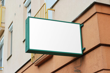 Blank white store sign design mockup. Street storefront shop, cafe, restaurant mounted signboard...