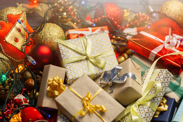 Holidays decoration background Christmas presents and box, garland lights and christmas tree balls decor 