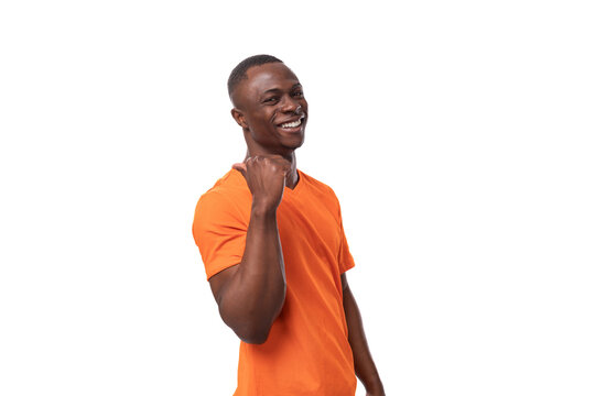 young positive happy american man in orange t-shirt with mock up isolated on white background