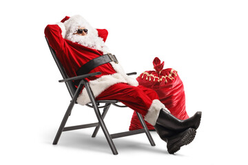 Santa claus wearing sunglasses and enjoying in a foldable chair