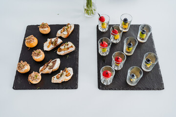 Table setting with snacks in a cup top view, varied menu, food treat in the office, food on a white background.