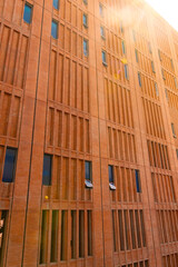 Orange brick wall of a high-rise building, exterior decoration style, building construction, classic style, looks solid.