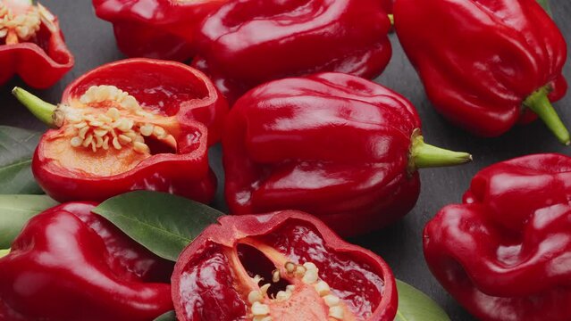 Red hot cayenne habanero peppers with habanero pepper halves move slowly along the frame. Nice vegetable pepper background for your projects.